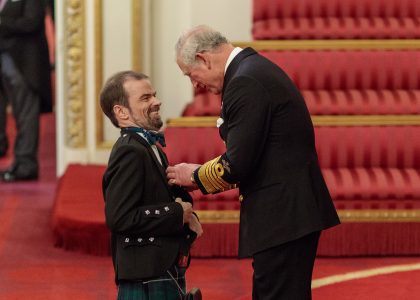 Grant Douglas recieving the MBE from Prince Charles at Buckingham Palace